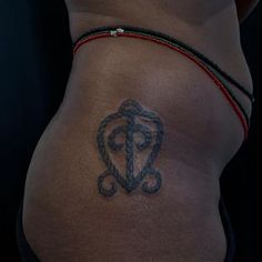 a woman's stomach with a tattoo on her lower half and the bottom part of her abdomen