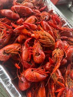 craws are being cooked in a pan on the table