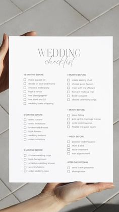 a person holding up a wedding checklist