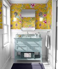 a bathroom with a sink, mirror and wallpaper