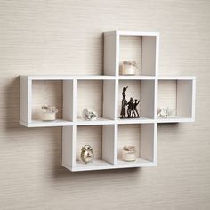 a white shelf that has some figurines on it