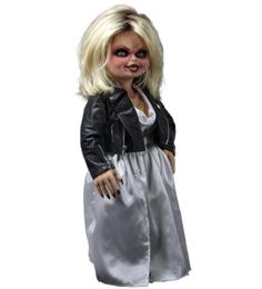 a doll with blonde hair wearing a silver dress and black leather jacket is standing in front of a white background