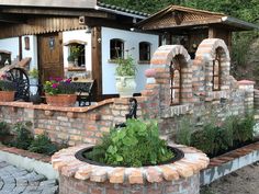 an outdoor garden area with brick walls and potted plants