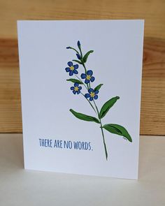 there are no words card with blue flowers on the front and green leaves on the back