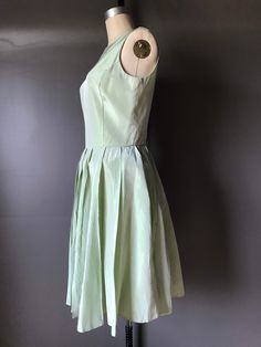 Photographed on a size 8 form Classic Green Spring Dress, Spring Dresses With Box Pleat And Full Skirt, Spring Party Vintage Pleated Dress, Classic Vintage Evening Dress For Summer, Chic Vintage Dress With Fitted Bodice For Spring, Spring Formal Dress With Box Pleat, Formal Spring Dresses With Box Pleat, Spring Vintage A-line Dress For Formal Occasions, Spring Vintage Dress For Formal Events, A-line