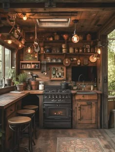 an old fashioned kitchen with wooden walls and flooring, pots on the stove top