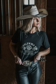 Tumbleweed Era western tee. Step into the Wild West with our vintage-inspired Western Tumbleweed shirt! This retro tee is perfect for anyone who loves the boho, vintage look. With a comfortable fit, it's a great choice to dress up or dress down. Whether you're heading out to a rodeo, exploring the desert, or just need a new fall shirt, this Western graphic tee has got you covered. So why wait? Order now and embrace your inner cowgirl with this must-have country shirt!• 100% combed and ring-spun Womens Western Shirts, Leather Artist, Western Tee, Western Graphic Tees, Fitted Shirts, Country Shirts, Retro Tee, Bandana Scarf, Flower Hats