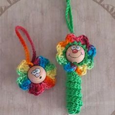 two crocheted ornaments with clown faces on them