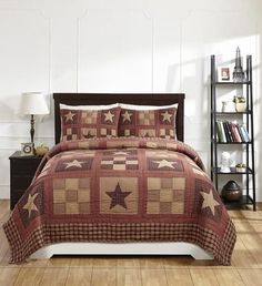 a bed in a room with a brown and white quilted comforter on it