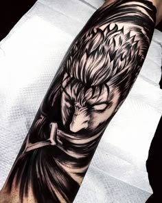 an arm tattoo with a black and white image of a man's face on it