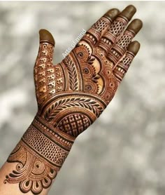 the hand is decorated with henna designs on it's fingers and palm hands