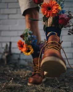 a pair of boots with flowers in them