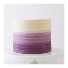 a cake with purple and white frosting on top