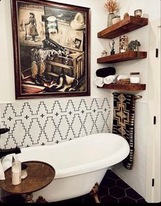 a white bath tub sitting under a painting on the wall