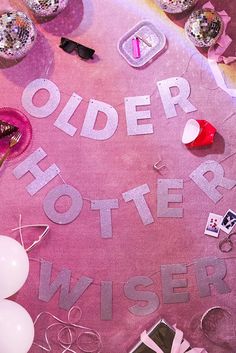 an overhead view of a table covered in confetti and other items with the words older mother wise written on it