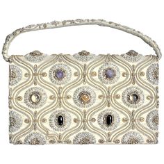 This vintage ornately embroidered and decorated clutch styled evening handbag was made in India in approximately 1940 in the period Anglo-Indian style. The outer shell of the purse is constructed of a heavy cotton with has been intricately embroidered with a combination of gold and silver toned wire and accented with inset cabachon polished stones. The earth tones of the cotton exterior are accented with silk lining and compartments, and is secured with a large snap clasp. The purse is labelled Purse Handmade, Silk Bag, Silver Bags, Vintage Clutch, Clutch Purse Evening, Fashion Collage, Evening Handbag, Evening Purse, Embroidered Bag