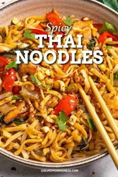 a bowl full of noodles with chopsticks in it and the title says spicy thai noodles