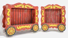 two red and yellow wooden toys with wheels on each side, one holding a door