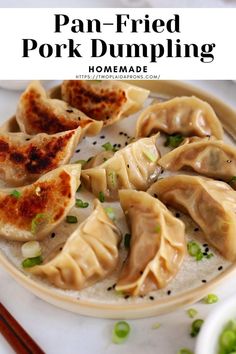 a plate with dumplings on it and chopsticks next to the bowl full of them