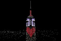 the empire building is lit up in red, white and blue for valentine's day