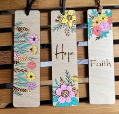 three wooden bookmarks with flowers and the words hope, faith written in brown ink