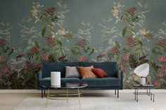 a living room scene with focus on the couch and wallpaper that looks like flowers