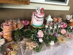 a table topped with lots of cakes and desserts