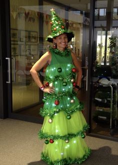 a woman wearing a green christmas tree costume