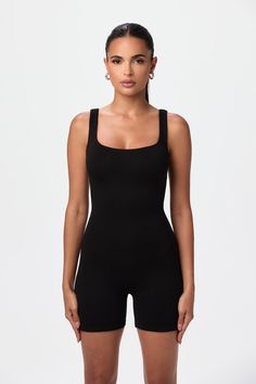 Our iconic bodycon romper features a scoop neckline with medium tank strap design. Easy pull on style and comfortable stretch. Dress it up or dress it down to create versatile looks. Lounge in it at home, too. NW/Legacy Collection Import 95% Viscose, 5% Spandex Models wears size X-Small True to size Double-lined Romper Bodysuit, Bodysuit Shorts, Sporty High-stretch Unitard With Thumbholes, Fitted One-piece Summer Unitard, Sporty Stretch Jumpsuits And Rompers With Built-in Bra, Compressive Solid Unitard With Thumbholes, Workout Bodysuit, Black Sleeveless Sporty Jumpsuit/romper, Romper Designs