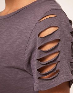 the back of a woman's shirt with cutouts on it