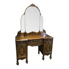 an antique wooden vanity with mirror on it