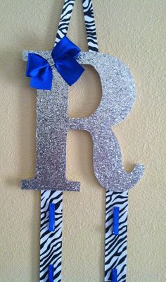 the letter b is decorated with zebra print and blue ribbon