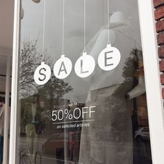 a storefront window with the sale sign on it