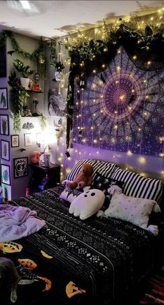 a bedroom decorated in purple and black with lots of lights on the headboard,