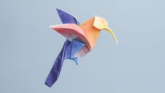 an origami bird flying in the sky