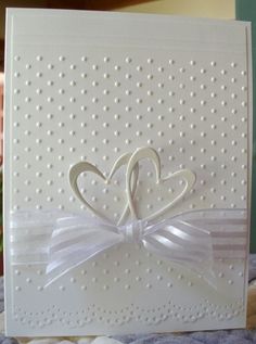 a close up of a card with a heart and ribbon on the front that says love