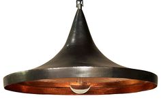 a large metal light hanging from a ceiling