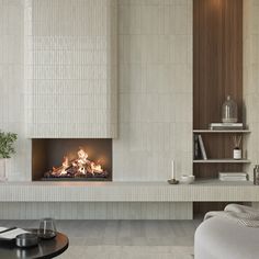 a living room with a fire place next to a couch and coffee table in front of it