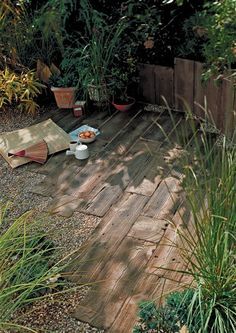 a wooden deck with potted plants and food on it