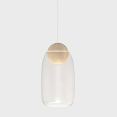 a white and gold light hanging from a ceiling