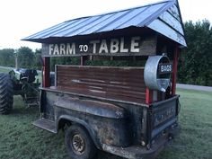 an old farm to table truck is parked in the grass