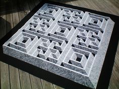 a black and white quilt on a wooden floor