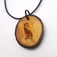 This wooden pendant is engraved with our original barn owl design. *This wooden pendant is created with locally sourced  wood and treated with mineral oil to preserve and hydrate the wood. *Comes with 20-inch waxed cord with a 2-inch chain extender for adjustable length. Dimensions The pendant is approximately 1.5 inches in diameter and approximately 1/8 to 1/4 inch thick Brown Carved Round Pendant Necklace, Brown Carved Pendant Necklace, Owl Wood Carving Necklace, Nature-inspired Wooden Pendant Jewelry, Owl Pendant Necklace, Round Necklace, Owl Design, Chain Extenders, Wooden Pendant