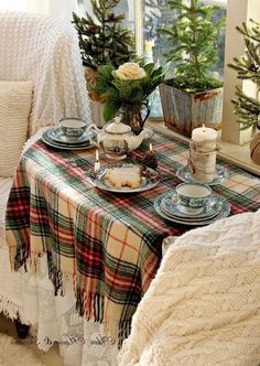 the table is set with dishes and cups