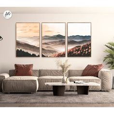 a living room with three paintings on the wall