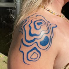 a woman with a blue tattoo on her shoulder