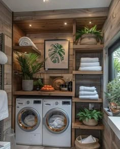 a washer and dryer in a room with wooden shelves on the wall above them