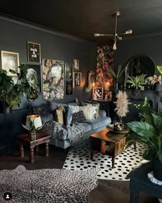 a living room filled with furniture and lots of plants