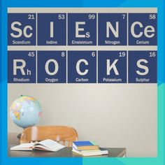 the science rocks wall decal is shown above a desk with books and an earth globe