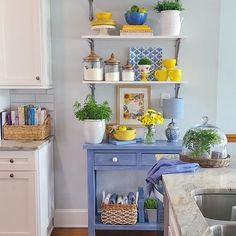 the kitchen is decorated in blue and white with lots of yellow flowers on shelves above the sink